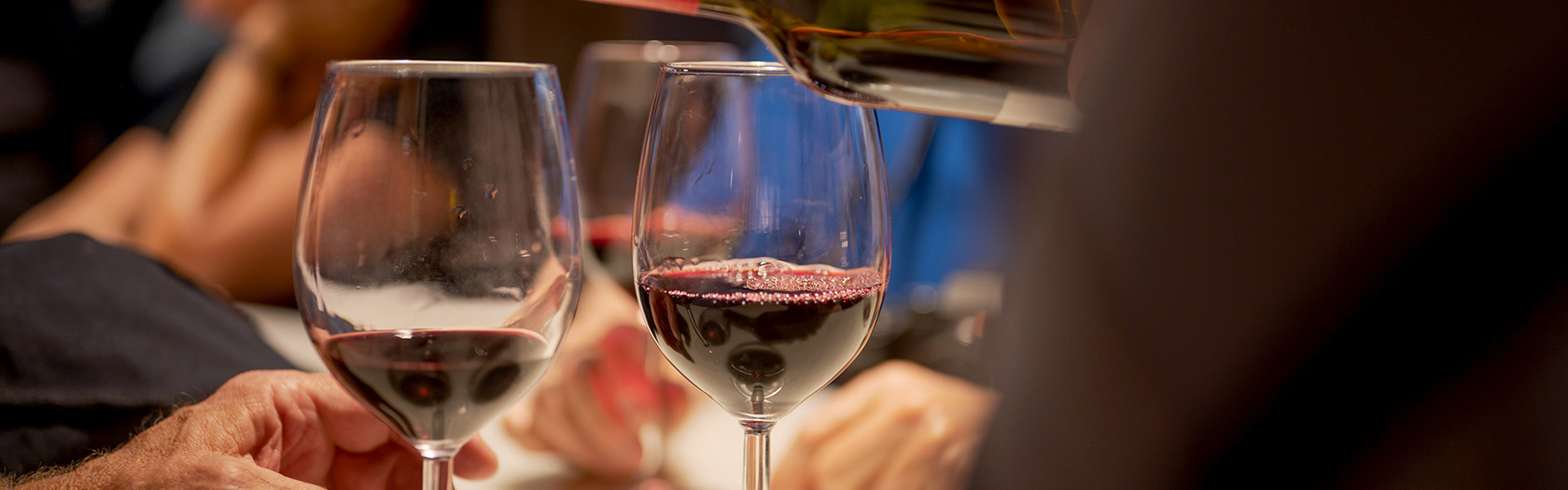 Wine being poured into two glasses